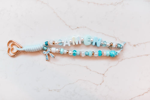 Amen 2-strand loop in sky blue and aqua with AMEN letter beads, a blue floral bow charm, a gold cross and a rose gold heart clasp