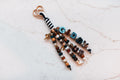 Giddy Up 4-strand loop in brown, teal and pearl with plaid GIDDY UP letters, a golden horse charm, a good luck horseshoe and a rose gold heart clasp