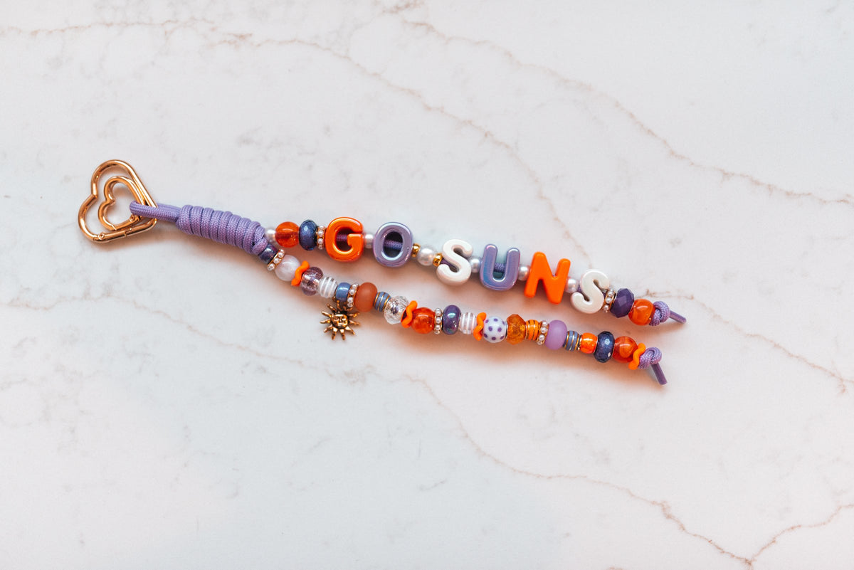 Go Suns 2-strand loop in orange and purple with GO SUNS letter beads, a gold sun charm and a rose gold heart clasp