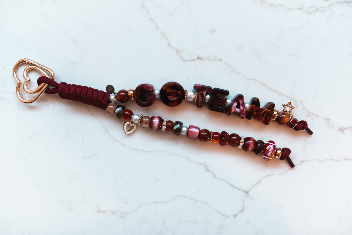Go Team 2-strand loop in maroon and tortoiseshell with GO TEAM letter beads, a football bead, a pearl heart, a gold star charm and a rose gold heart clasp