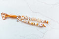 Grammy 2-strand loop in honey, butter yellow and cream with GRAMMY letter beads, a little house charm, a floral cube bead and a rose gold heart clasp