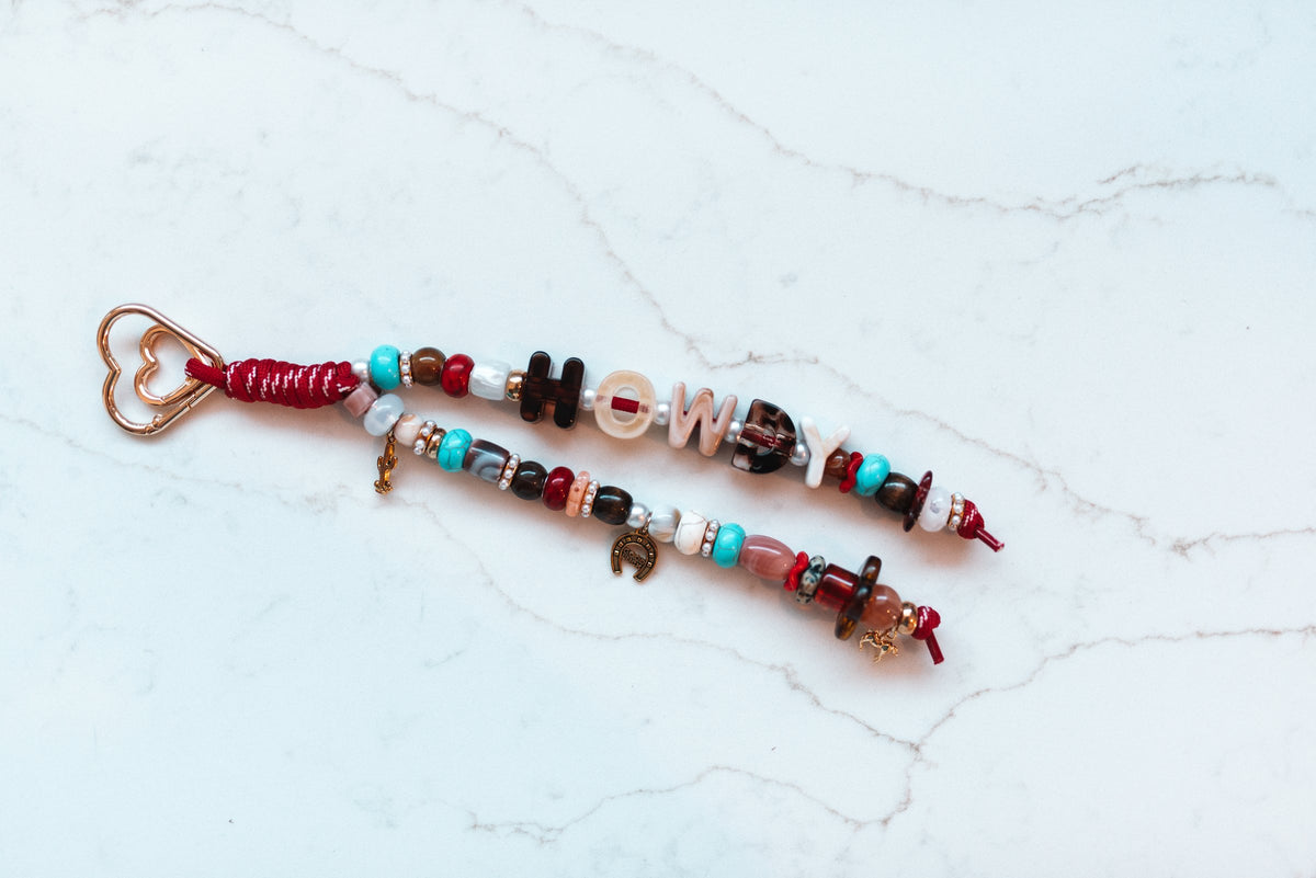 Howdy 2-strand loop with HOWDY letter beads, turquoise and red western beads, cactus, horseshoe and horse charms and a rose gold heart clasp