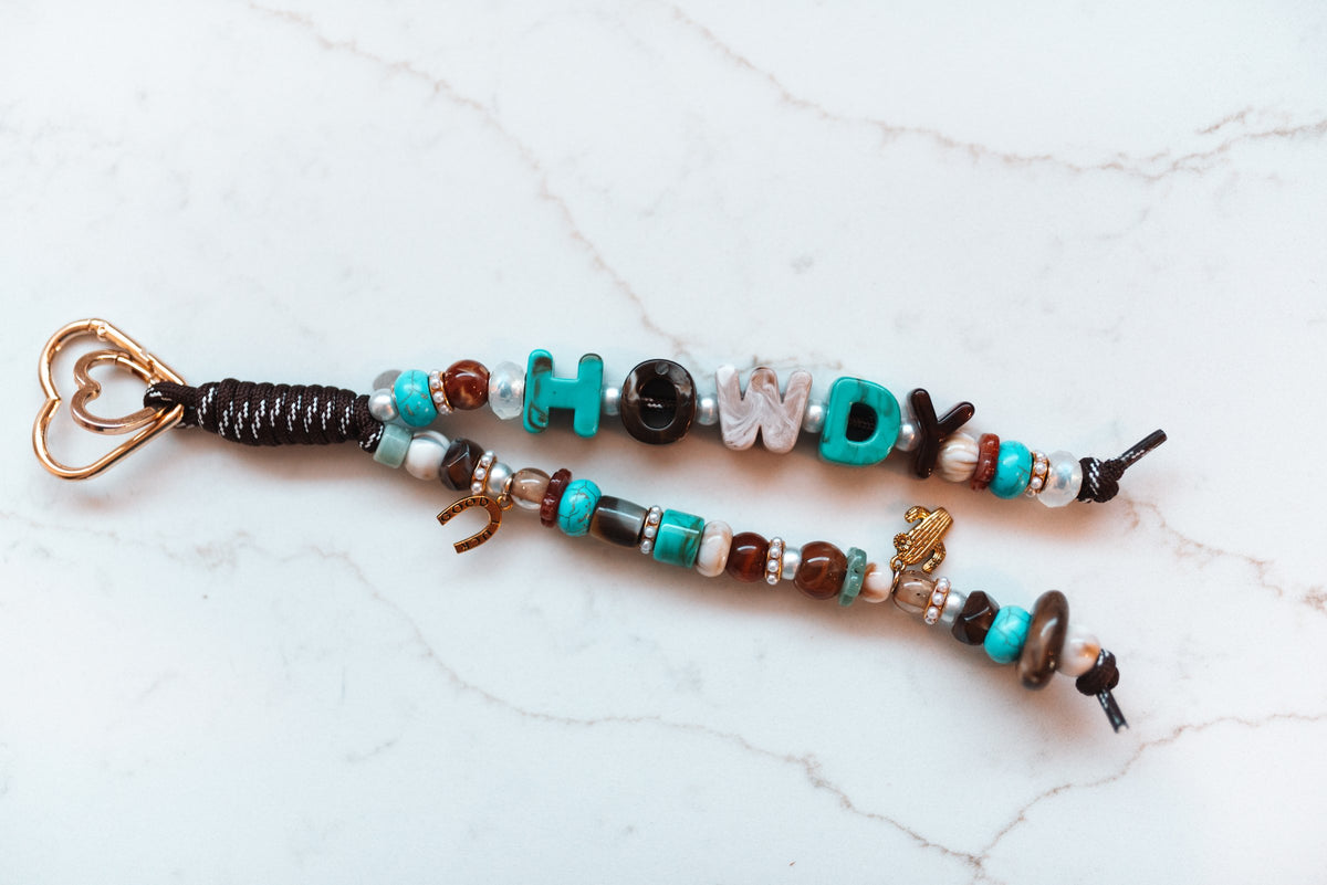 Howdy Turquoise 2-strand loop with turquoise and brown HOWDY letters, turquoise and agate beads, cactus and horseshoe charms and a rose gold heart clasp