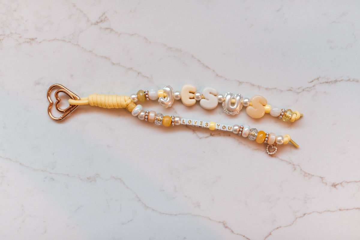 Jesus Loves You 2-strand loop in butter yellow with pearly JESUS letters, LOVES YOU letter tiles, a pearl heart charm and a rose gold heart clasp