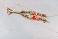 Let Them 2-strand loop with colorful LET THEM bubble letters, polka dot beads, a daisy and ladybug charm and a rose gold heart clasp