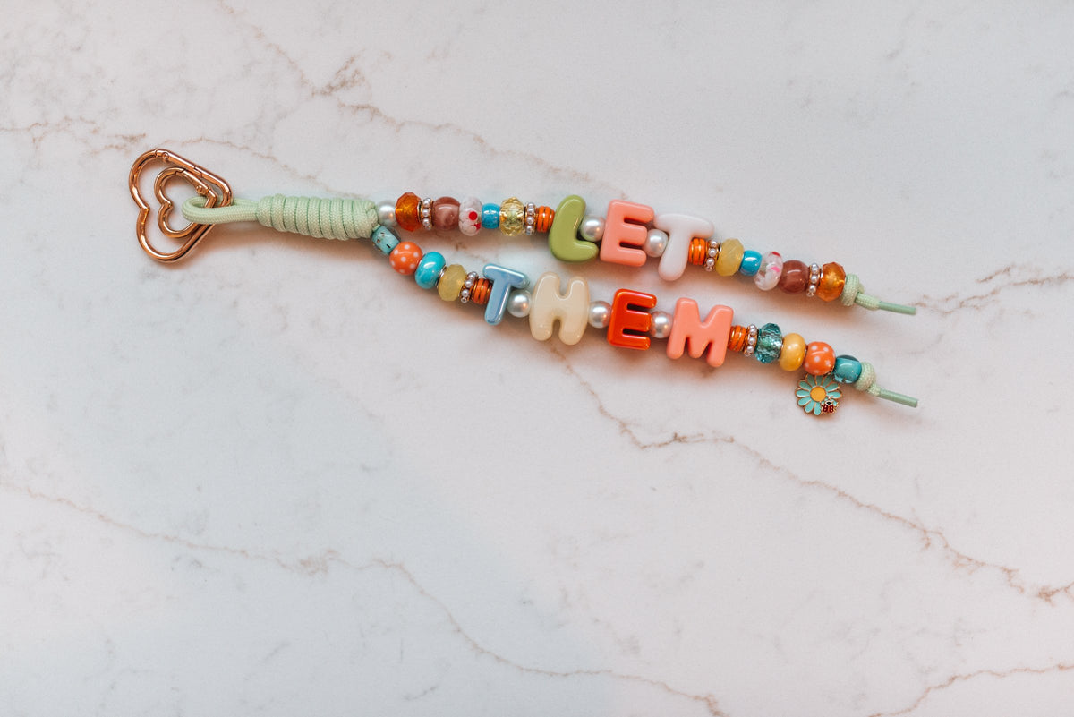 Let Them 2-strand loop with colorful LET THEM bubble letters, polka dot beads, a daisy and ladybug charm and a rose gold heart clasp