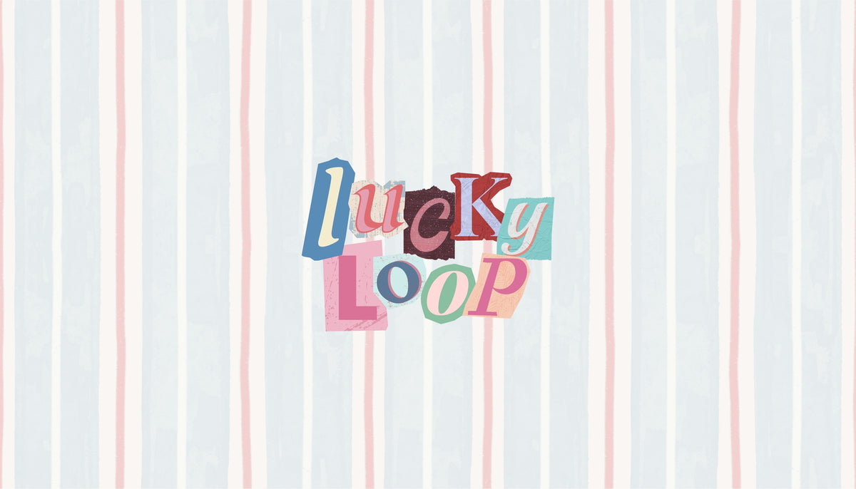 The Lucky Loop logo in cut-paper collage letters on a soft blue and pink striped background