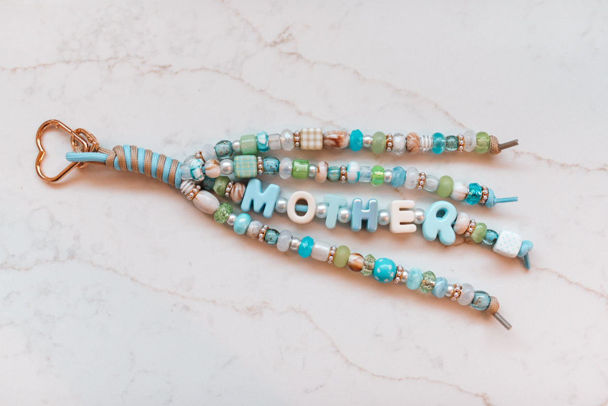 Mother Luxe 4-strand loop in aqua, sage and cream with MOTHER letter beads and a rose gold heart clasp