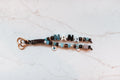 Nana 2-strand loop in brown and sky blue with plaid, cream, black and blue NANA letters, a butterfly charm, a pearl heart and a rose gold heart clasp