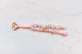 Pilates Princess loop — pink and pearl 2-strand bag charm spelling PILATES and PRINCESS on a rose gold heart clasp