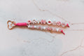 Princess 2-strand loop in pink and white with PRINCESS letter beads, sparkle beads, a gold carriage charm and a rose gold heart clasp