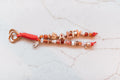 Salty 2-strand loop in coral, terracotta and shell tones with SALTY letter beads, a baroque pearl charm, a tiny seashell and a rose gold heart clasp
